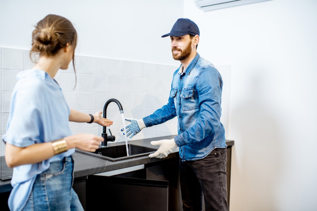 Contractor explaining finished kitchen work to a client
