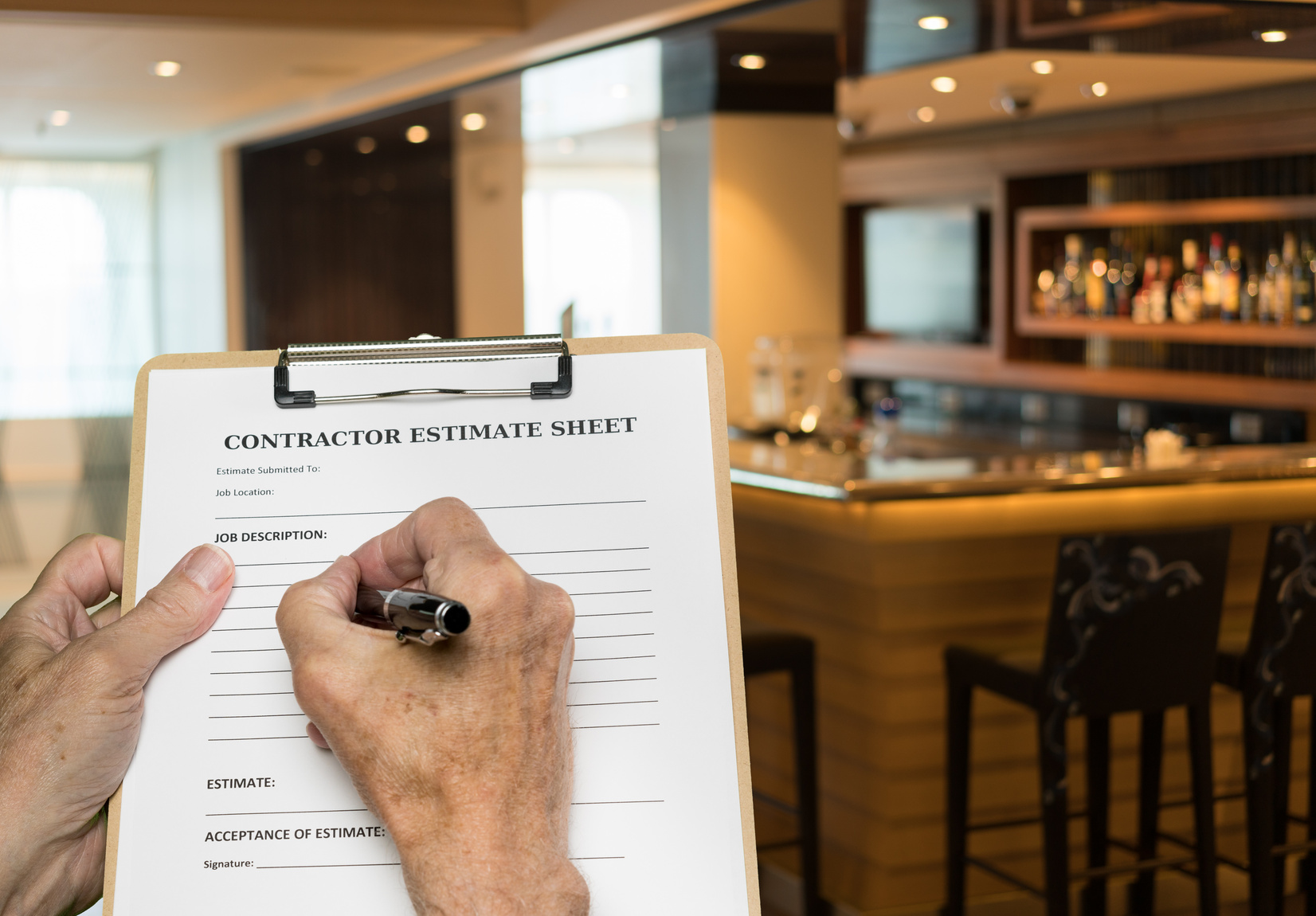 Contractor filling out a project estimate on site