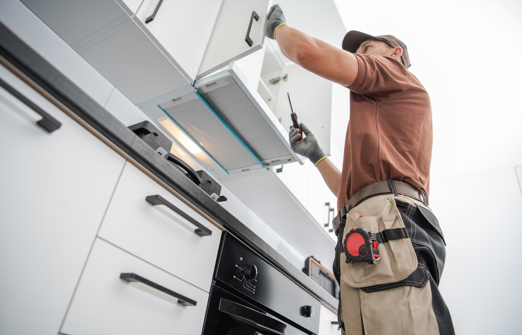 Cabinetmaker finishing a new kitchen installation