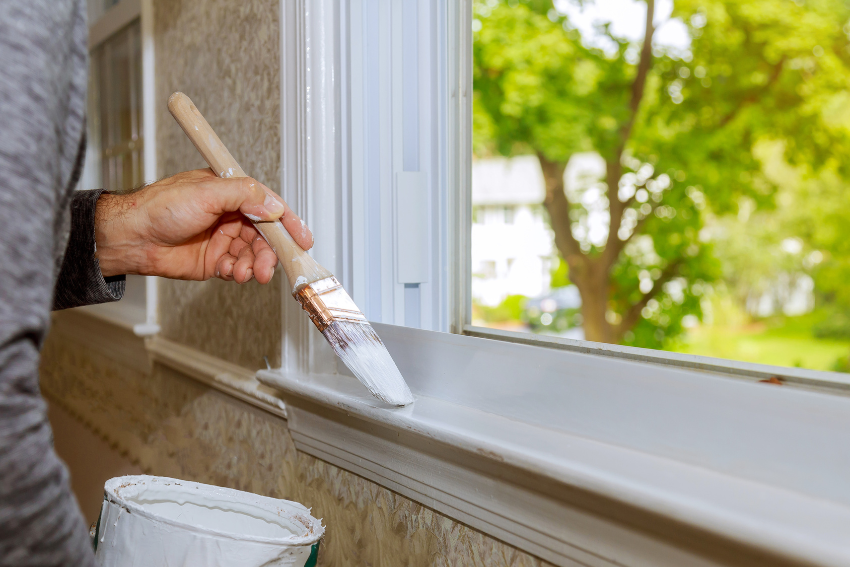 Brush painting window trim white